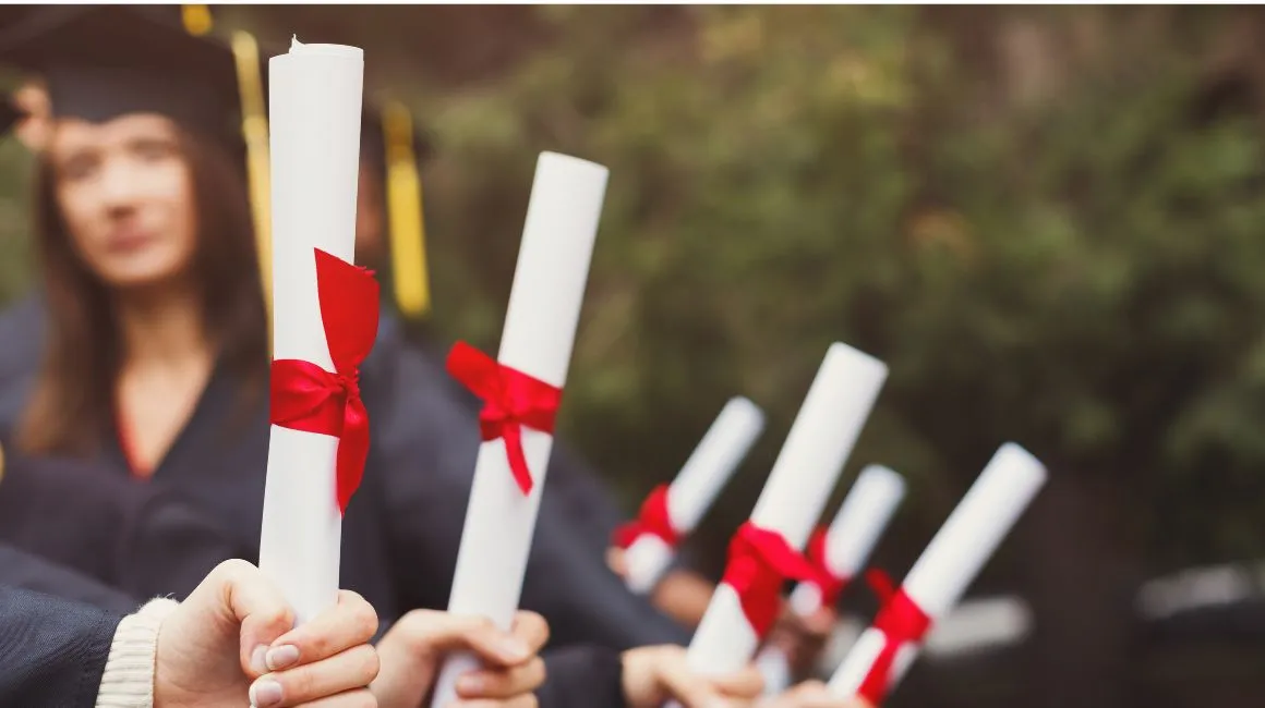 Students holding diplomas